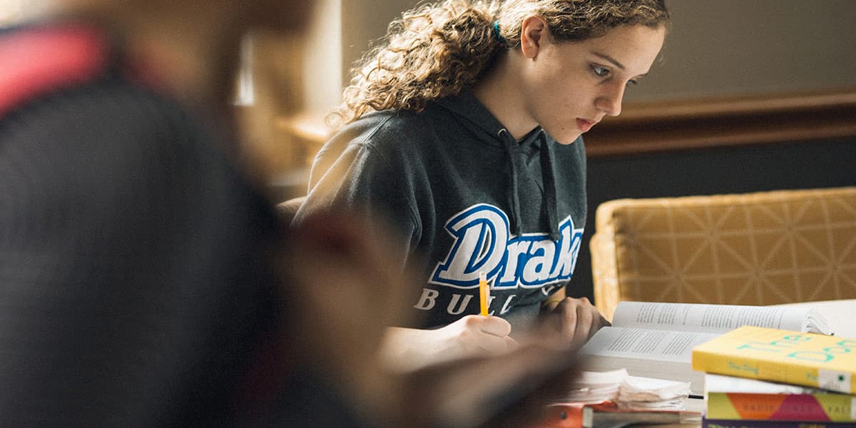Drake University student studying in the library 