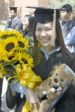 Rachel Tan is showered with sunflowers and a teddy bear after graduating last May.