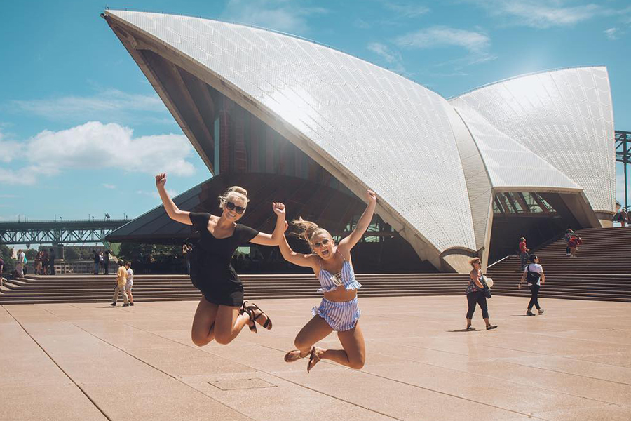 During a study abroad trip, two Drake students click their heels in front of the Sydney Opera House