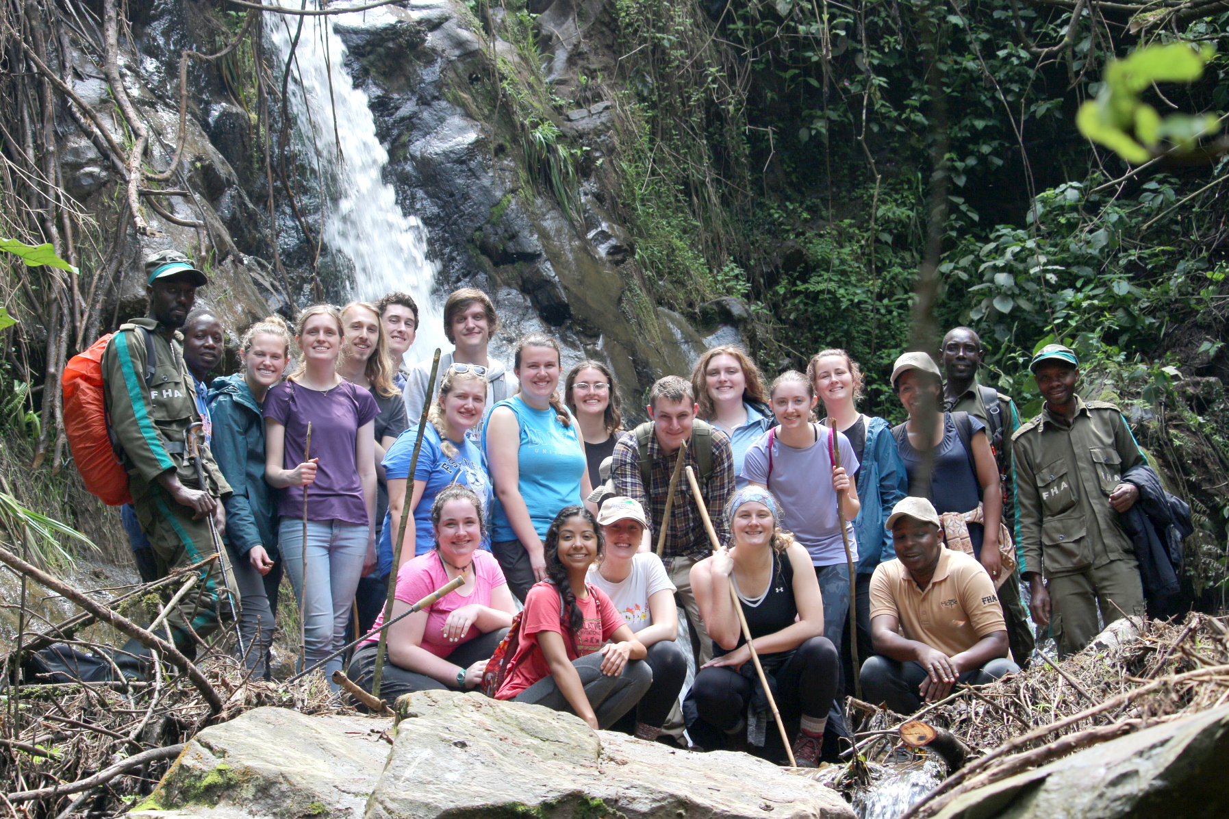 For a J-Term trip, a group of Drake students pose in front of a waterfall during a hike