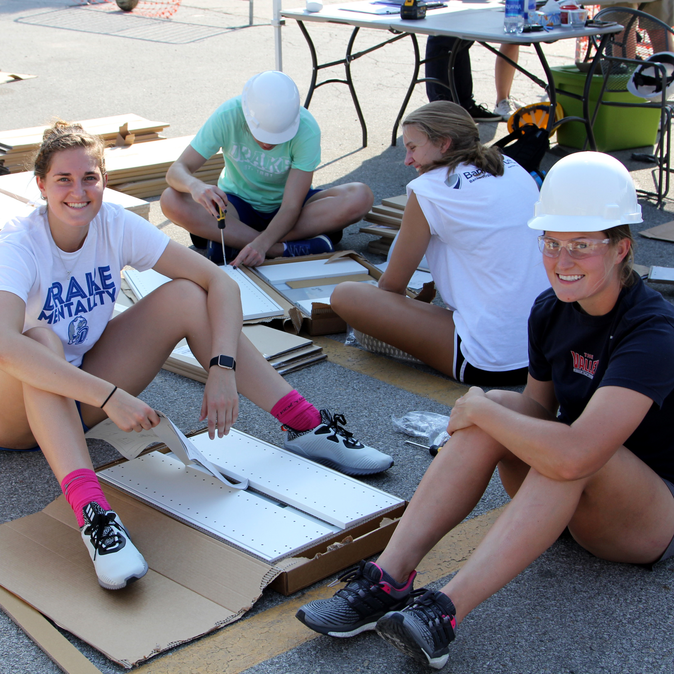 Drake students organize and drill holes into building materials on DU Good Day