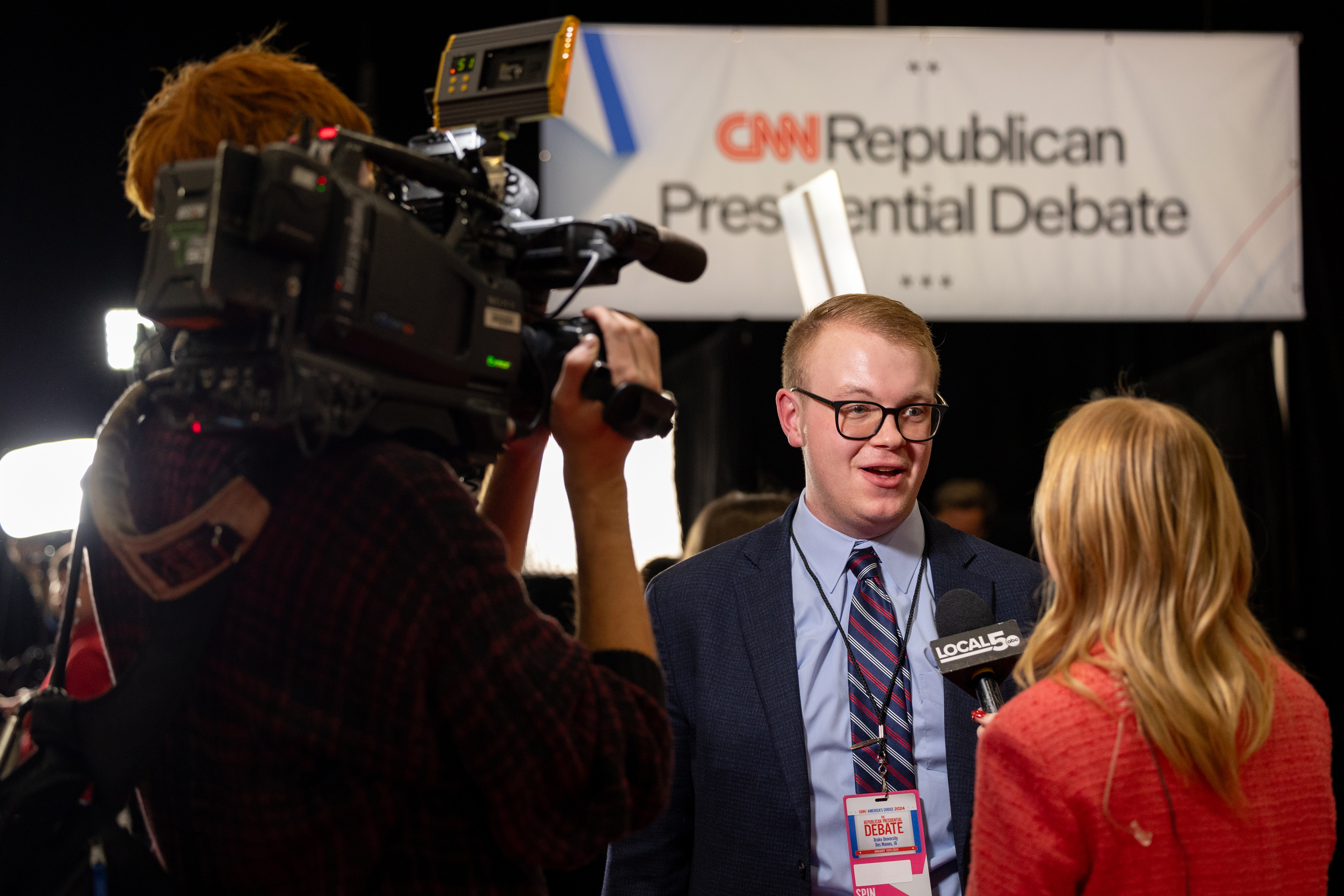 A Drake student is interviewed by a local news station during the Republican presidential debate