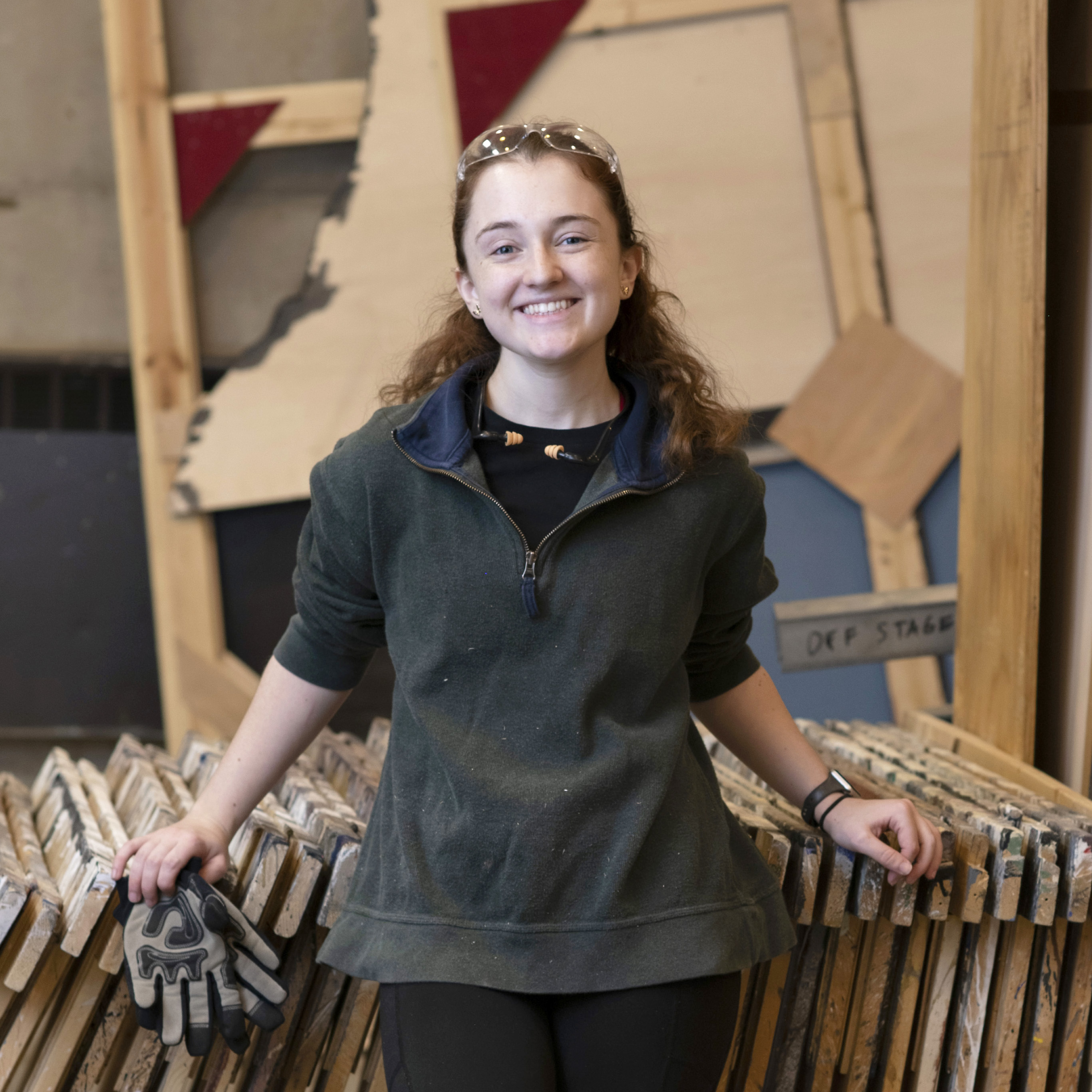 A Drake student works backstage on a campus theatre production