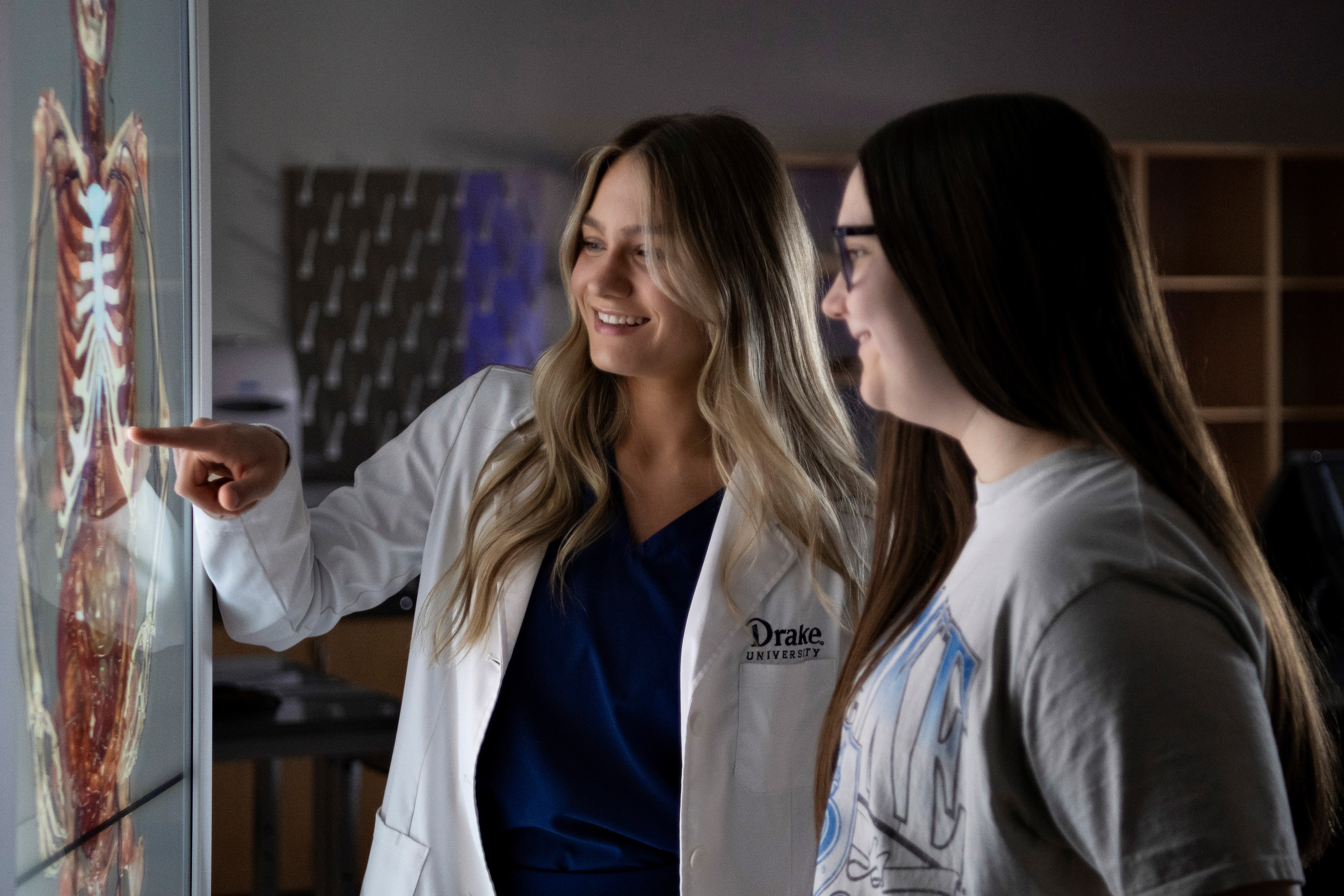 Two Drake students use an anatomage table to learn about the human body's systems