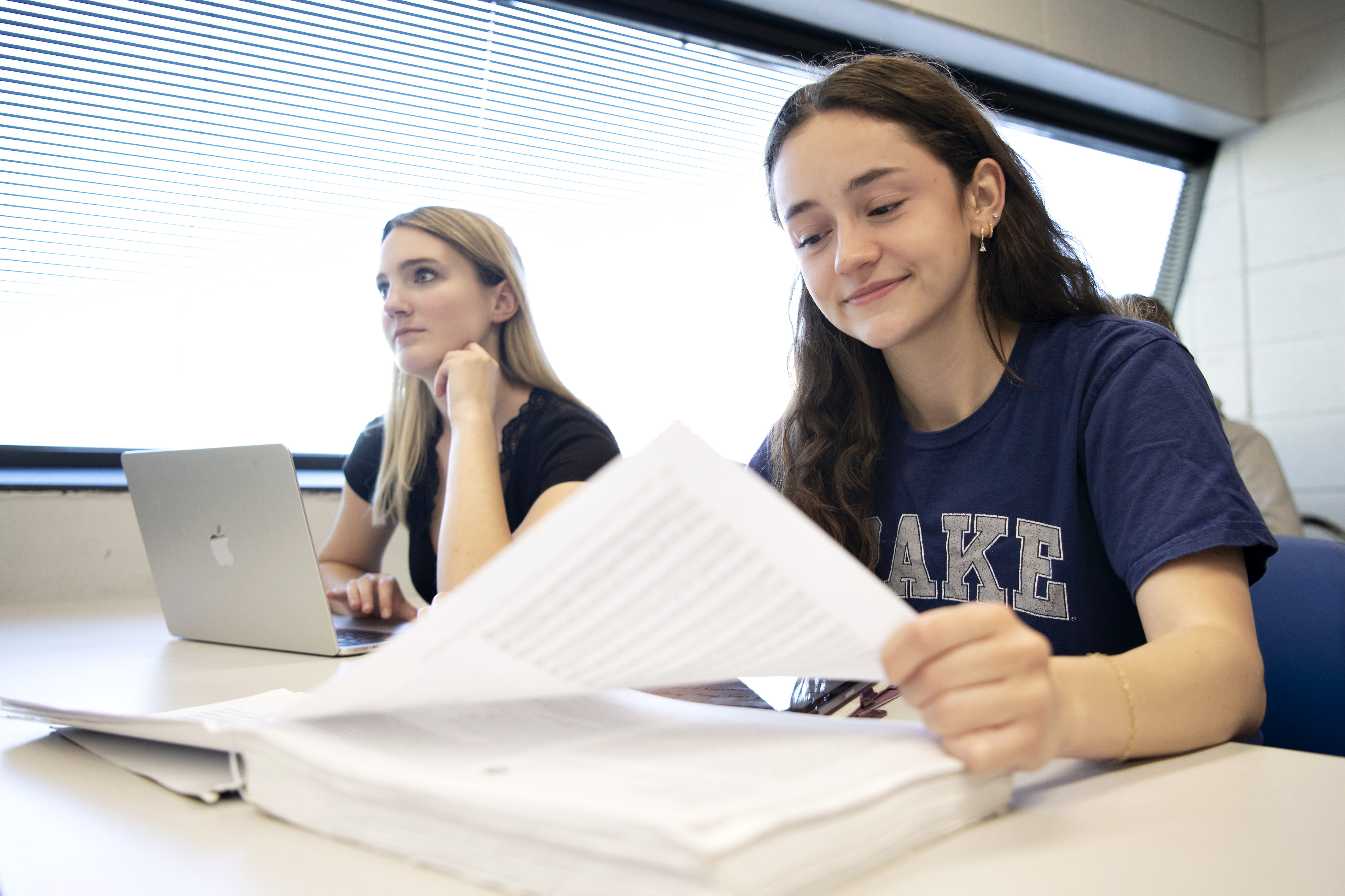 Drake students look upward at the board or review their notes at the start of class