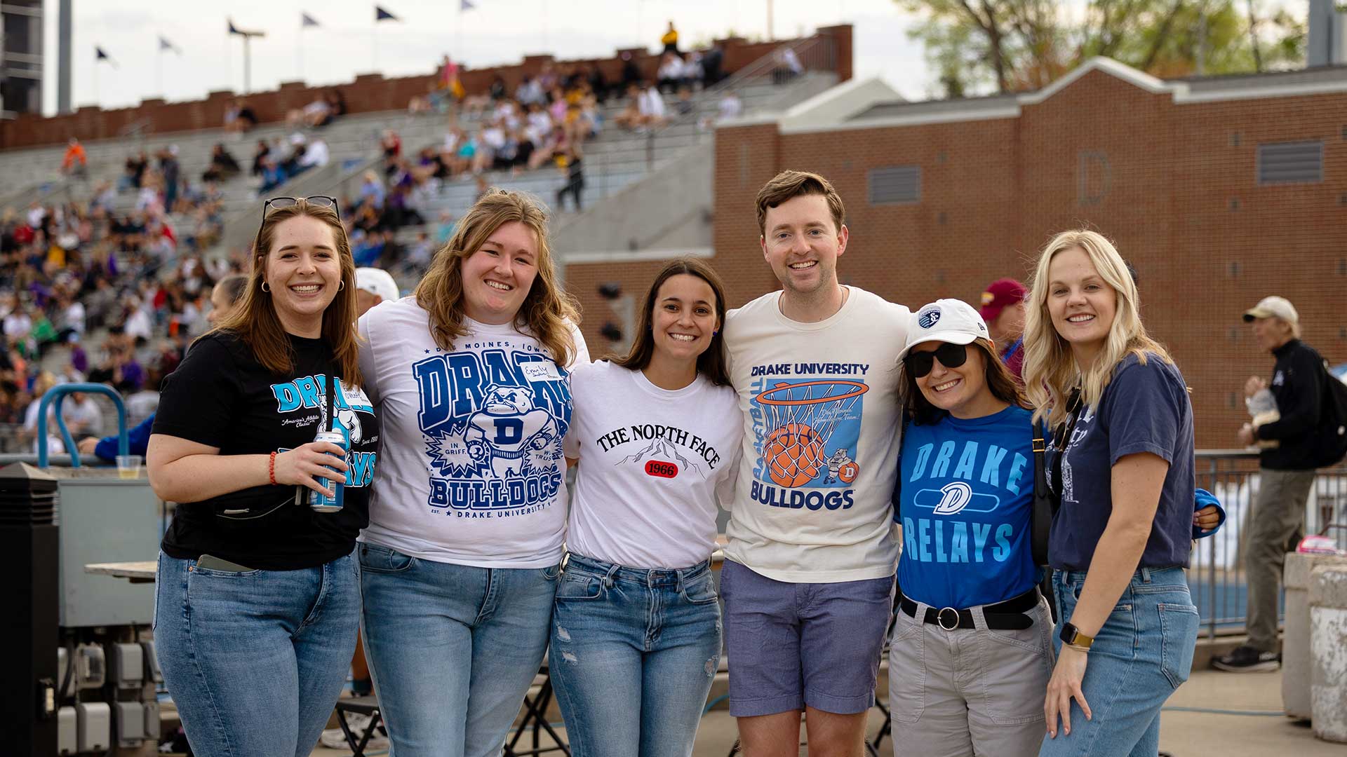 Group of 6 Drake Alumni at "Lets DU Drinks" beside the stadium during Relays.