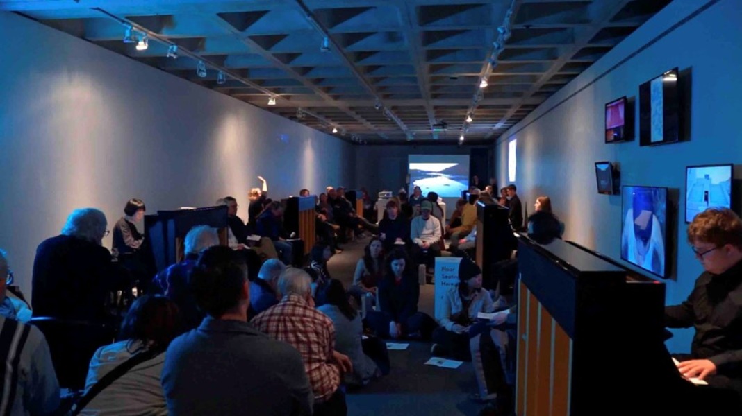 A group of people at Anderson Gallery during 16 Pianos, and art show.