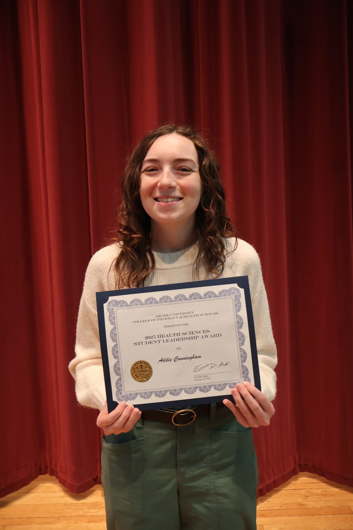 Addie Cunningham holding an award