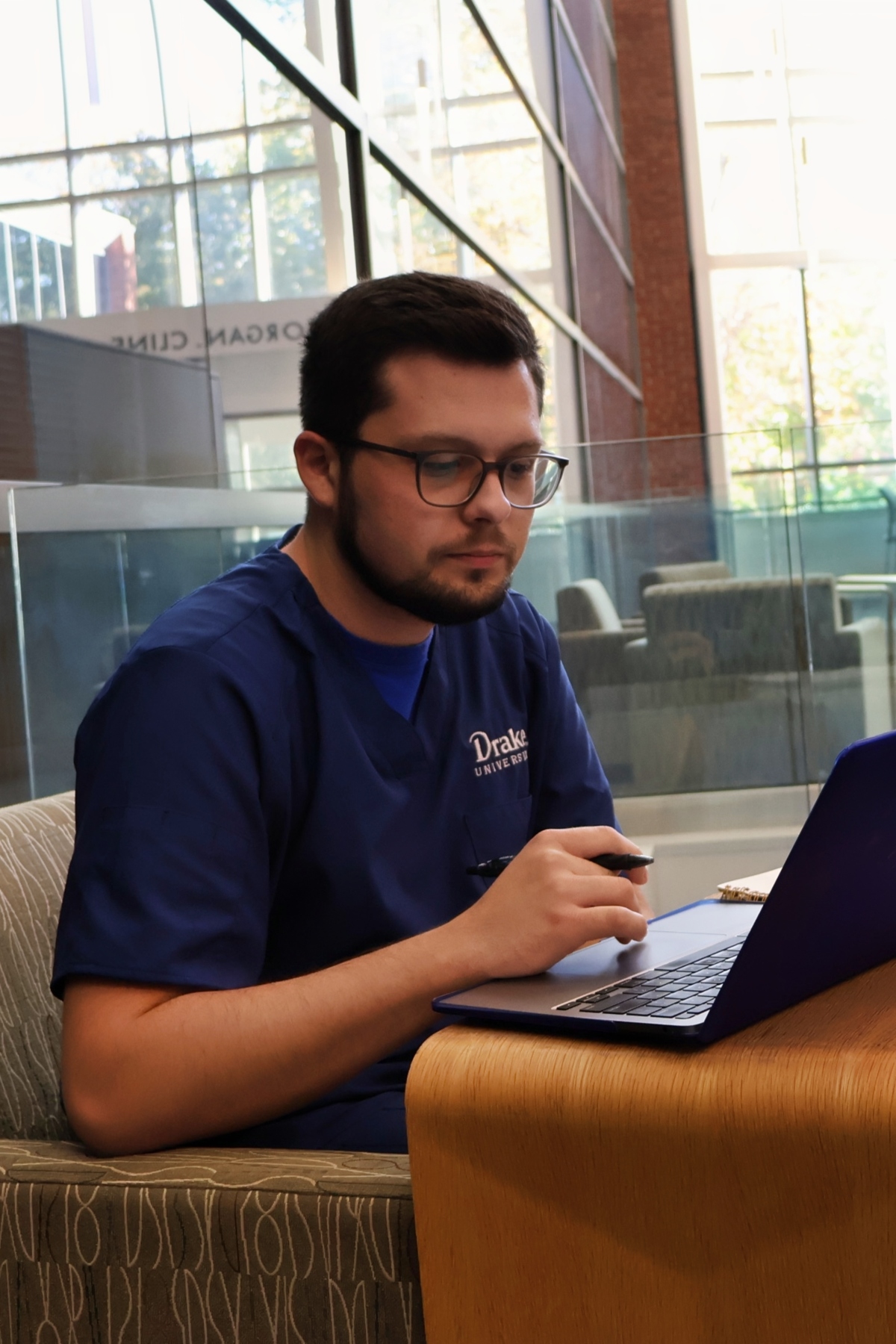 Armin Dogic studies on his laptop in the Cline Atrium