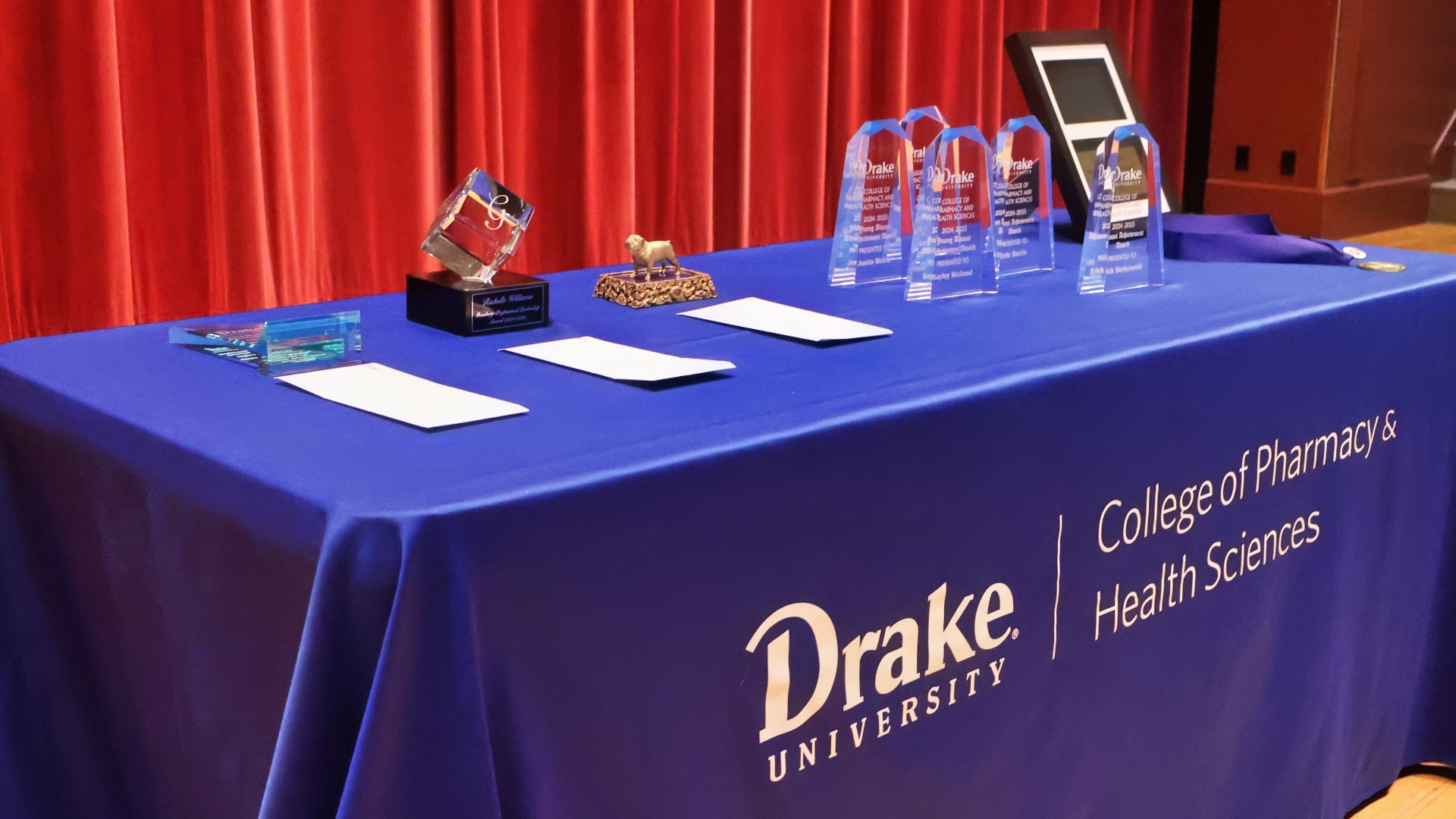 Table with Drake CPHS awards on top of a stage