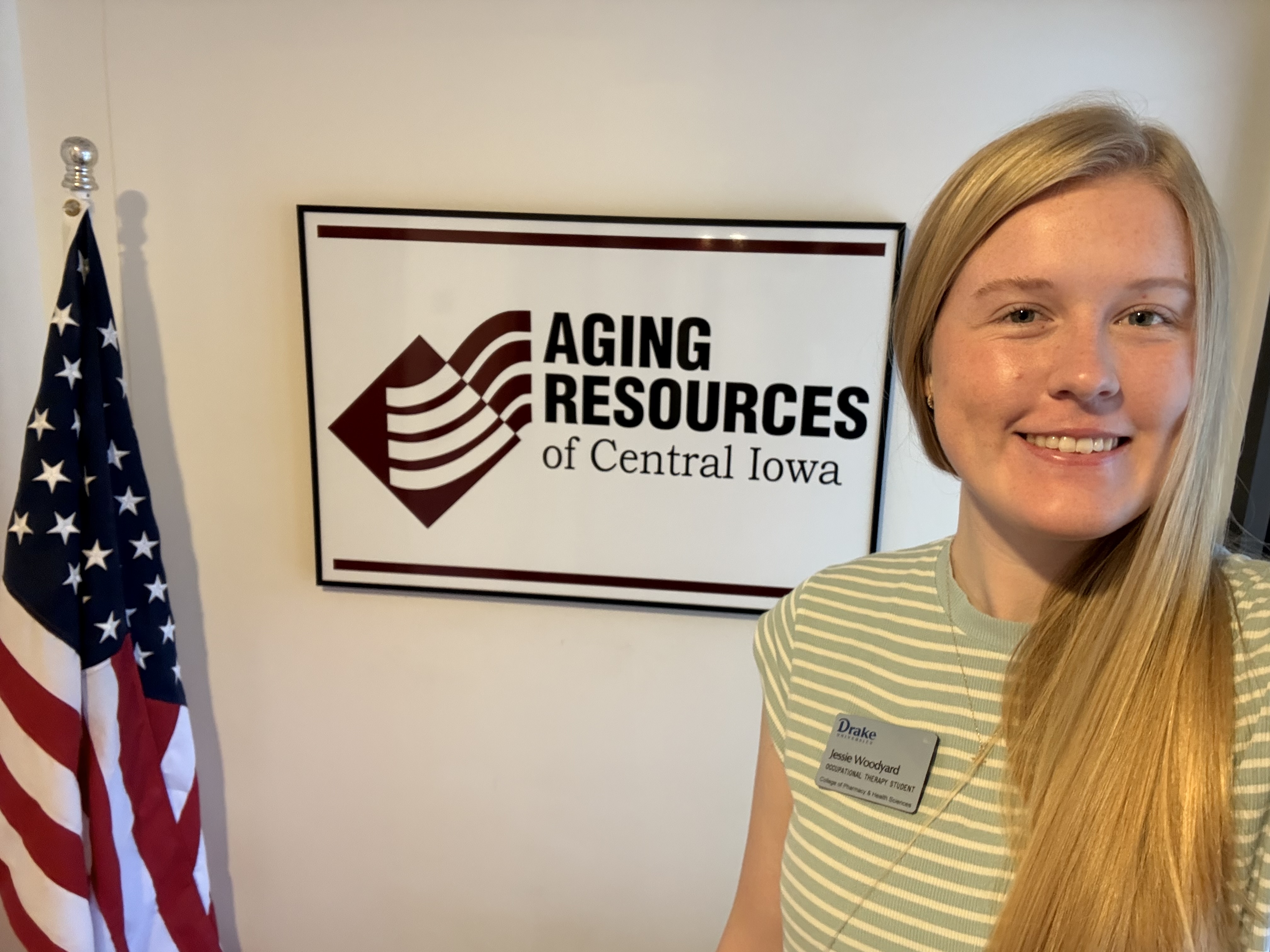 Jessie Woodyard selfie in front of Aging Resources of Central Iowa sign