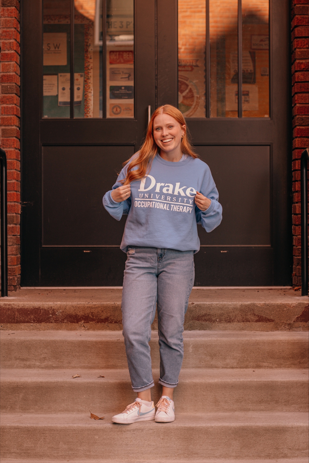 Lexi Lehman poses in a Drake Occupational Therapy sweatshirt
