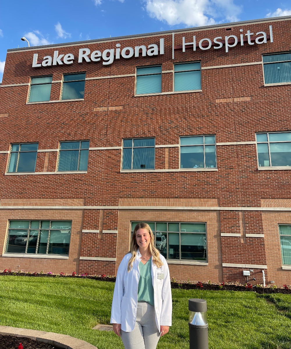 Elaina Hines standing in front of her rotation site building at Lake Regional Hospital