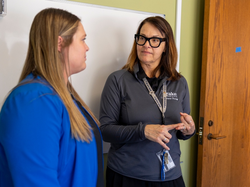 A Drake OT student listens to her professor's instructions