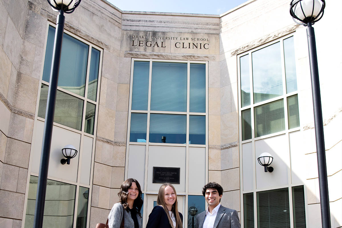 Three Drake Law Students standing in front of the Drake University Law School Legal Clinic.