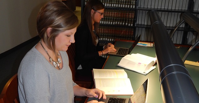 Two individuals research at Drake's law library