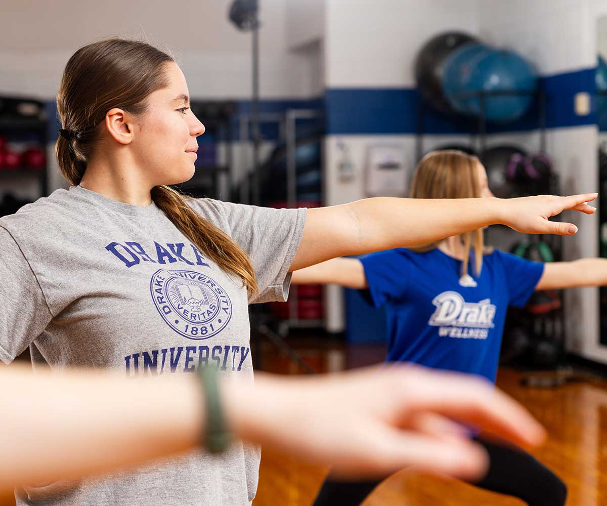Three students doing yoga together.