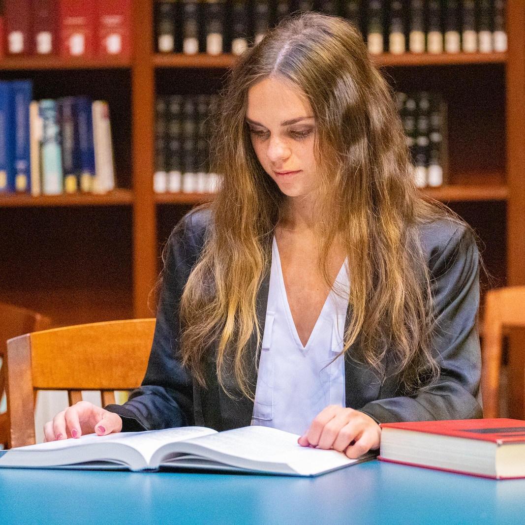 A woman studies in a library.