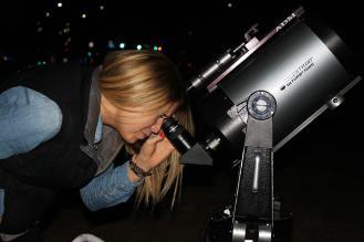 student looking through a telescope