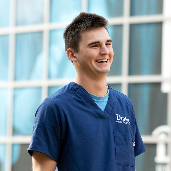 Male student in scrubs.