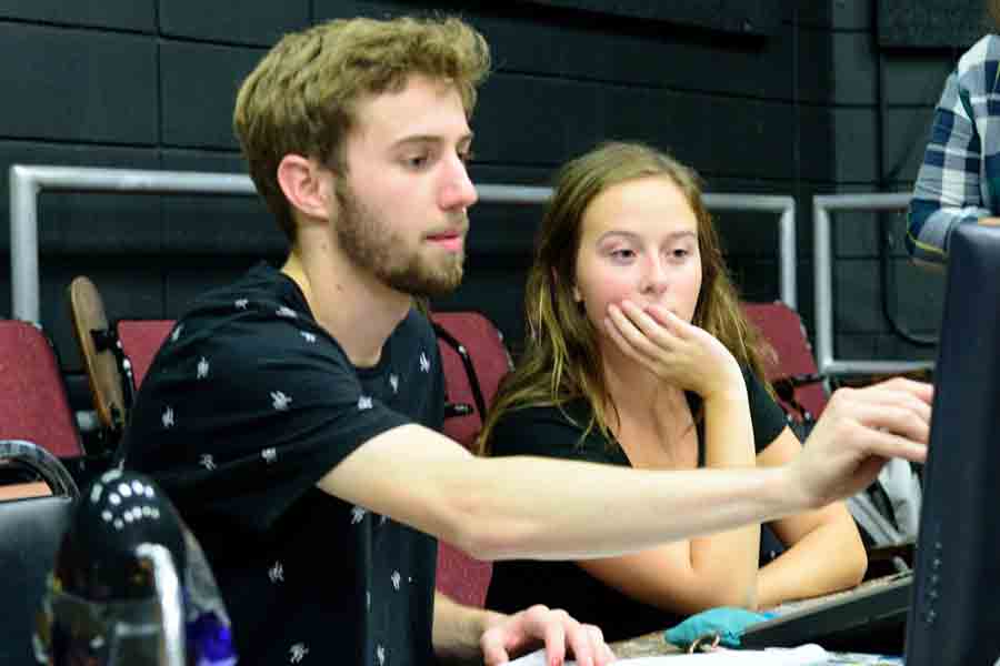 Two students look over a monitor