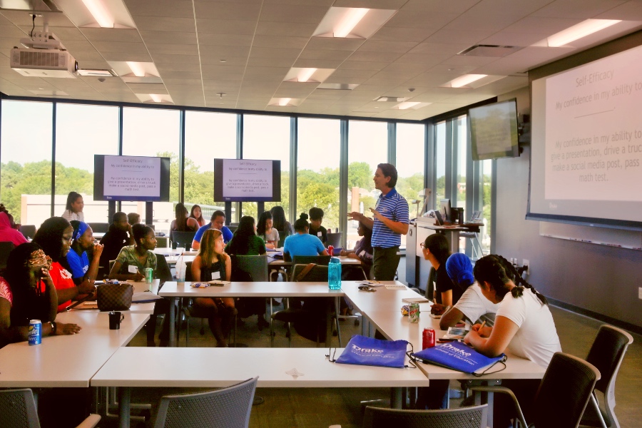 A professor working with students in an soe classroom