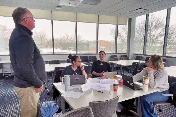 A professor speaking to students