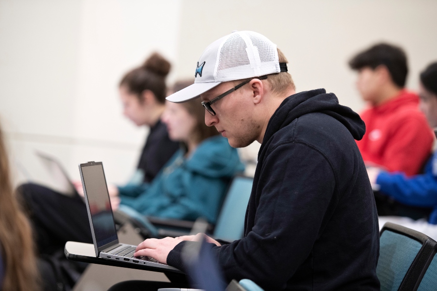 A student enrolled in one of Drake's 3 to a Health Sciences Degree and Joint Programs studies course materials from a laptop