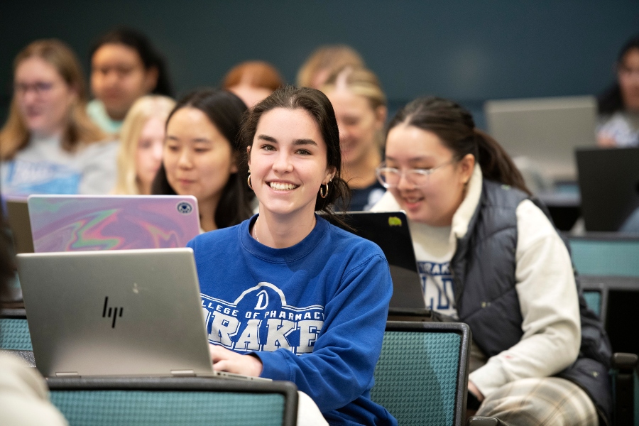 Health Sciences students sitting in a lecture hall at Drake review their notes on their laptops