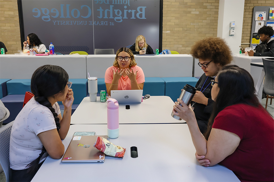 Students from Drake's A.A. in Business, Organization, and Professional Studies program meet for a study session in a campus common area