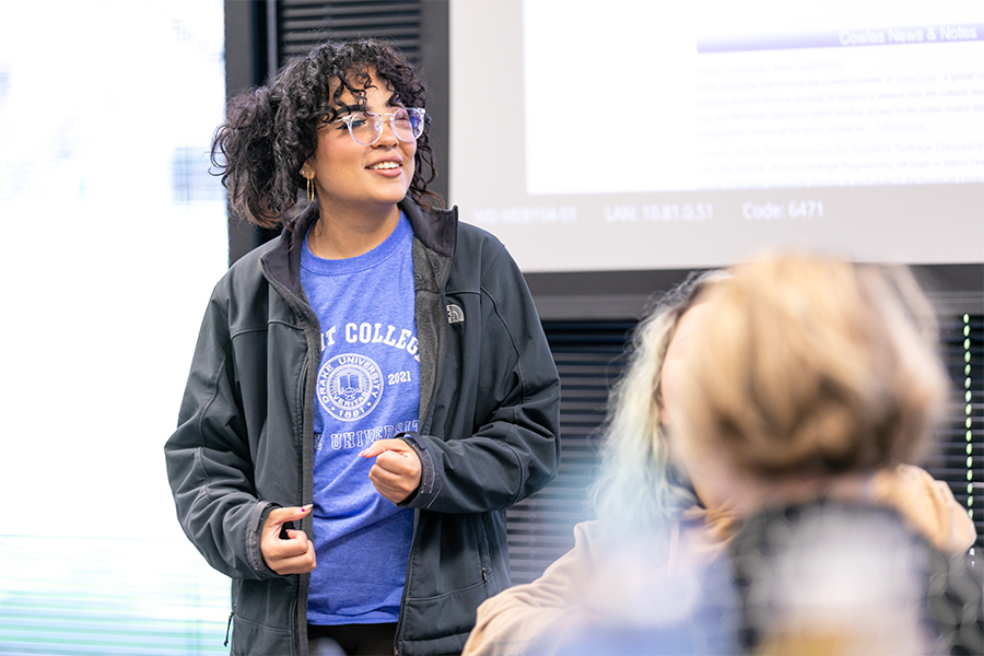 A student enrolled in Drake's A.A. in Integrated Arts, Sciences, and Humanities program presents their practicum project to their classmates