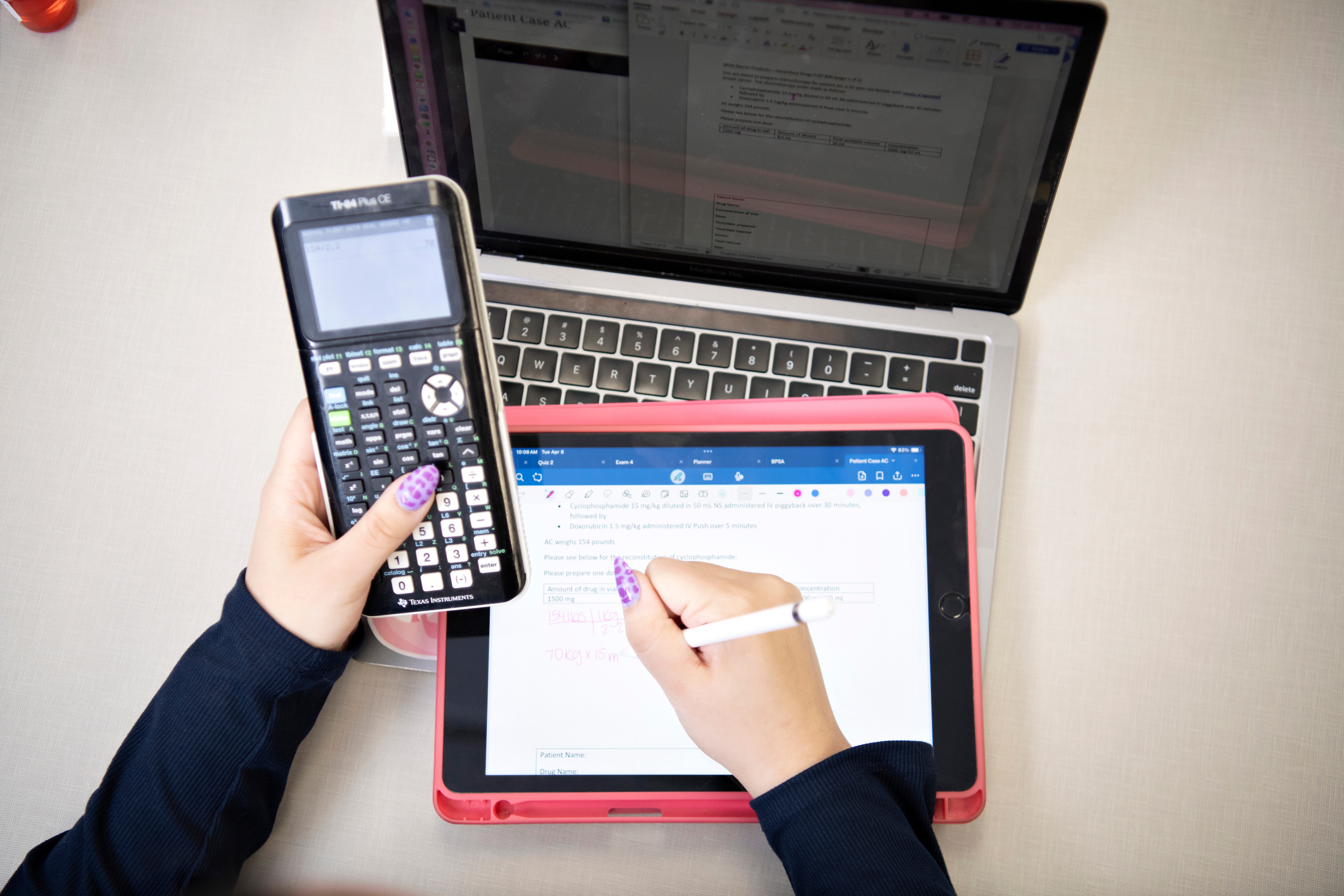 A Drake ABSN student studies materials with a tablet and calculator during an NCLEX-RN review class