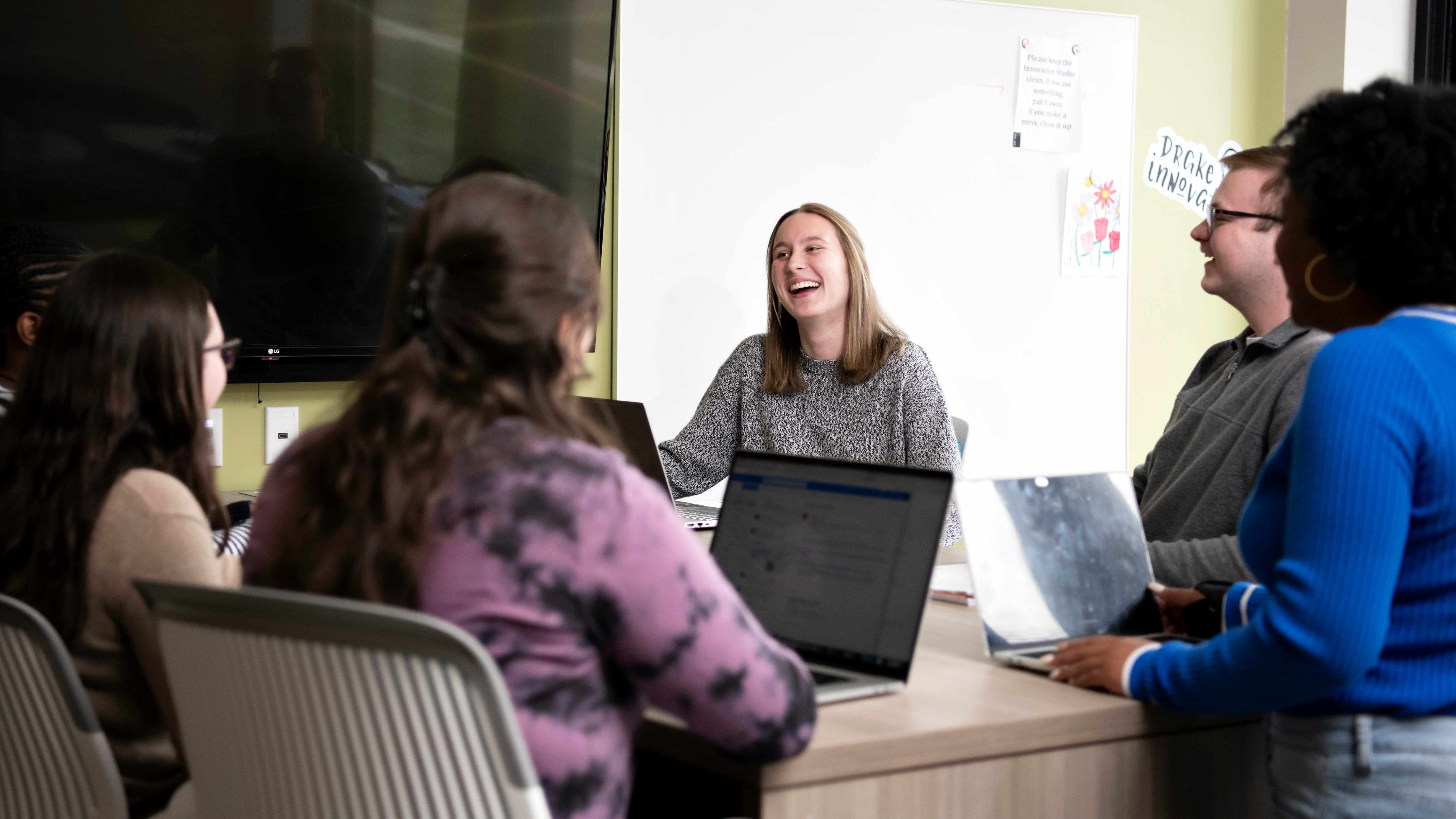 A group of Drake Anthropology and Sociology majors meet with their laptops for a group project