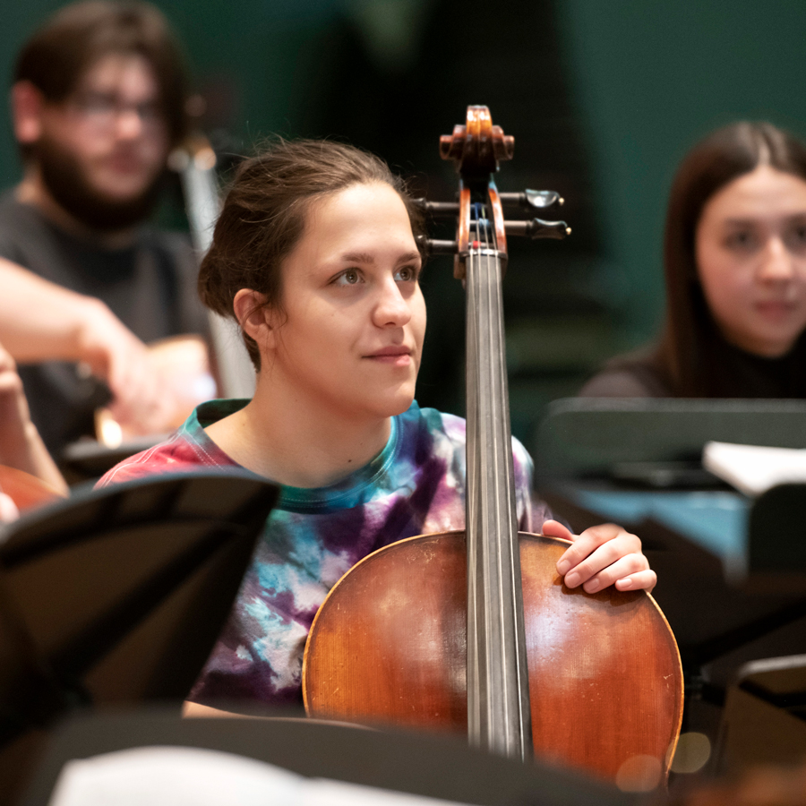 A cello major at Drake listens to feedback during rehearsal