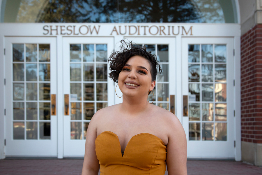 A Drake Applied Music Major poses in front of Sheslow Auditorium before their senior recital