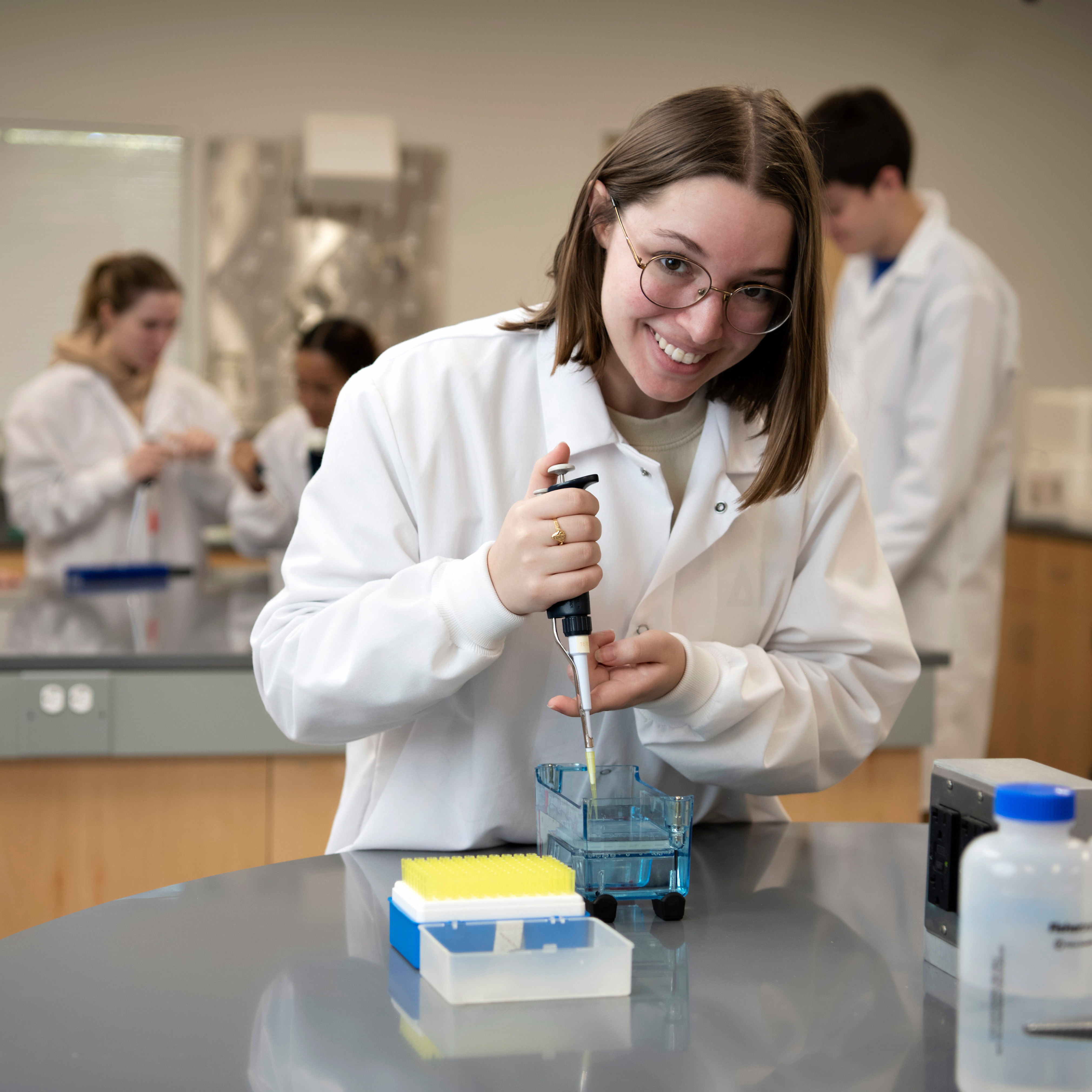 A Drake Biochemistry, Cell, and Molecular Biology student practices taking samples in a campus laboratory