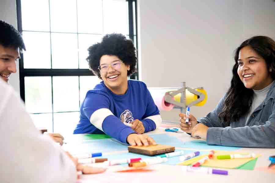 Students in Drake's Black Diaspora Studies program prepare for a service learning project that will involve markers and colored paper
