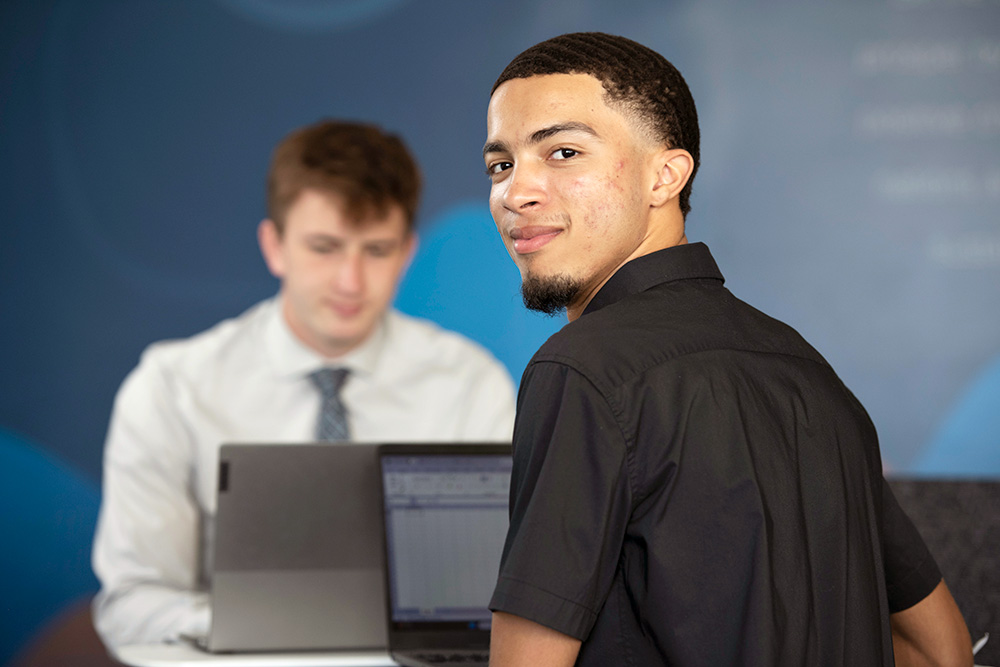 Two Computer Science students from Drake complete an assignment during an internship