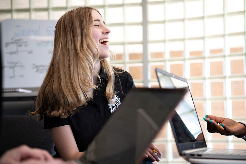 A group meeting featuring Drake Computer Science students with their laptops