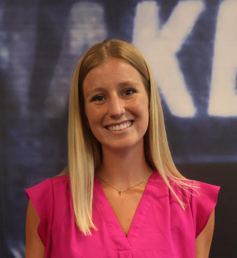 Drake Diabetes Concentration student Anna Braun PharmD’25 holds a forensic science textbook