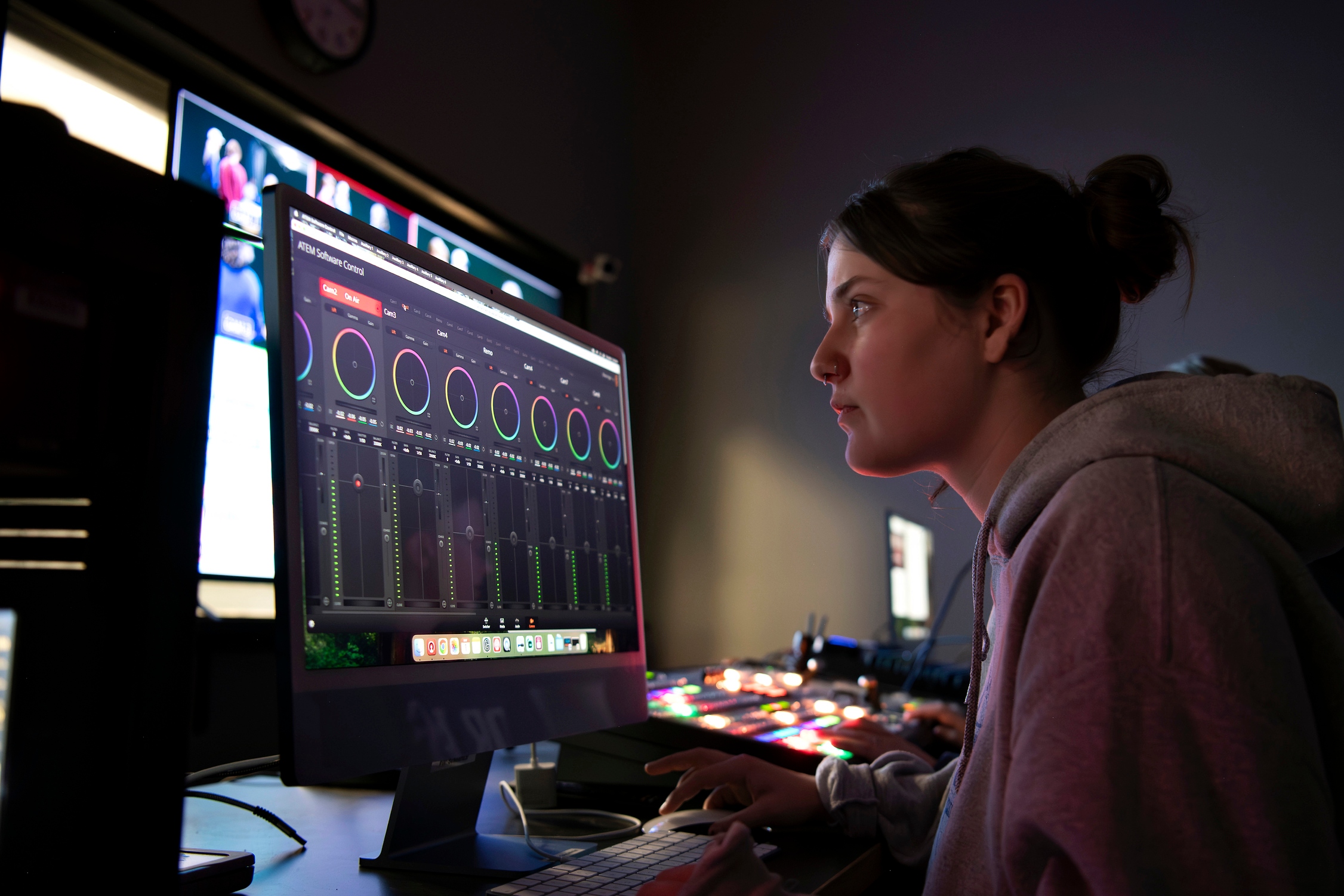 A Drake Digital Media Production major studies an audio program on a computer monitor in a campus production studio