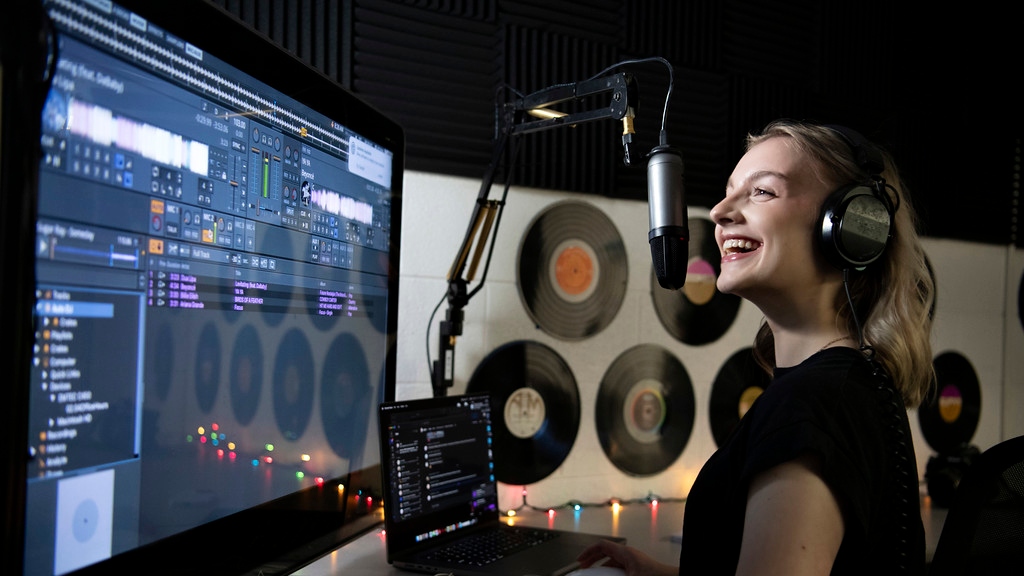 A Drake University Digital Media Production Major conducts a radio program in a campus studio
