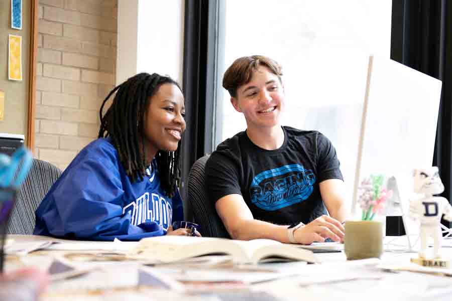 Satisfied with their work, two English majors lay out and edit one of Drake's student magazines in a campus computer lab
