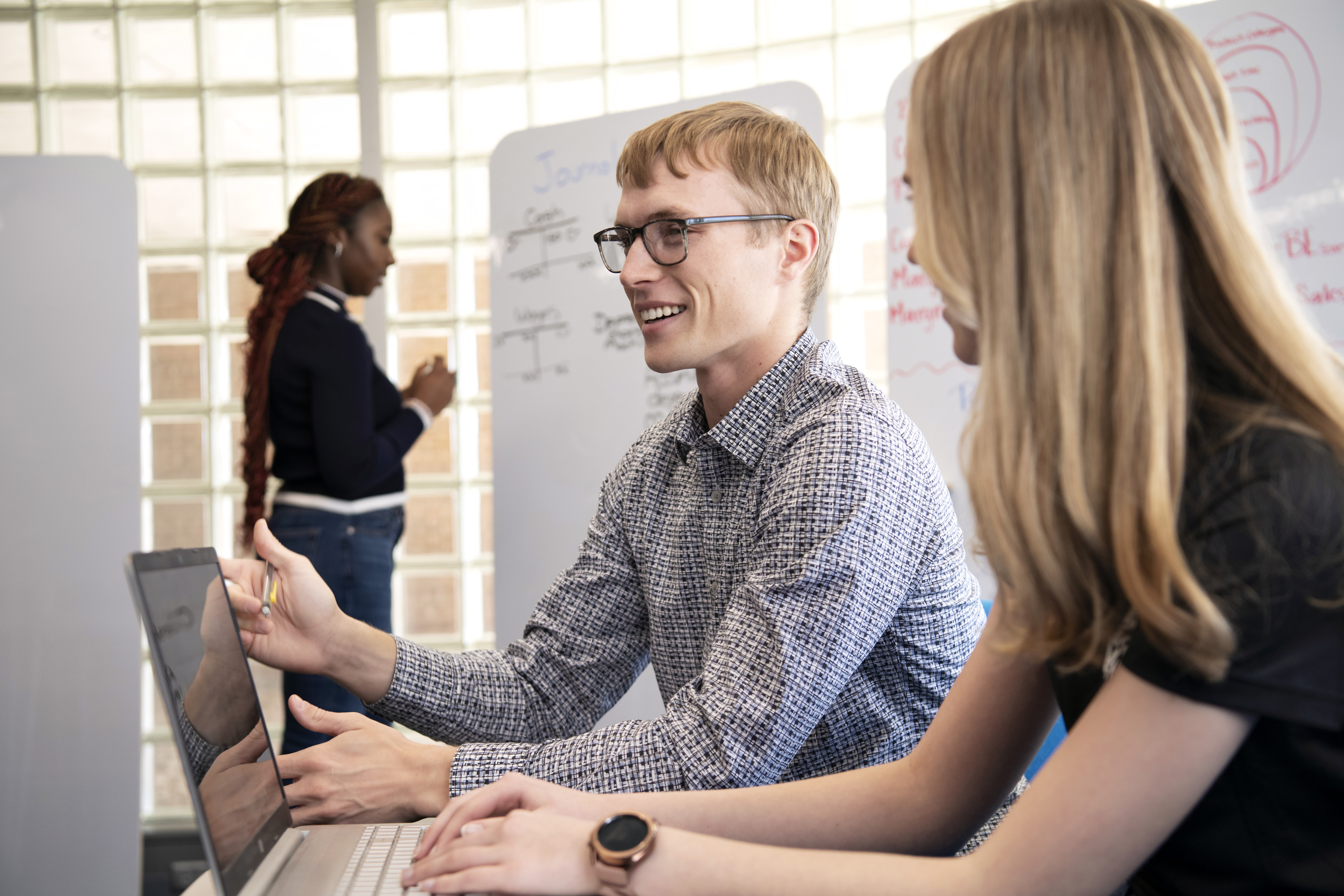 In Drake's Buchanan Center for Entrepreneurial Leadership, students work on a business plan together, including brainstorming and recording strategies