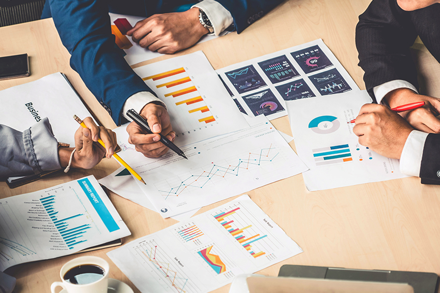 For a business-related challenge, Drake Finance majors analyze a series of graphs printed on paper to identify a solution