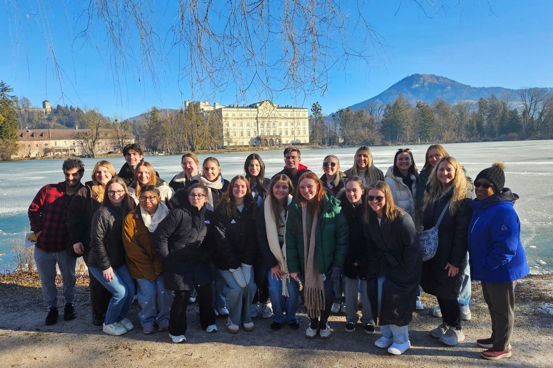 A group of Drake students taking the Global and Comparative Public Health Concentration pose outdoors during a winter study abroad trip