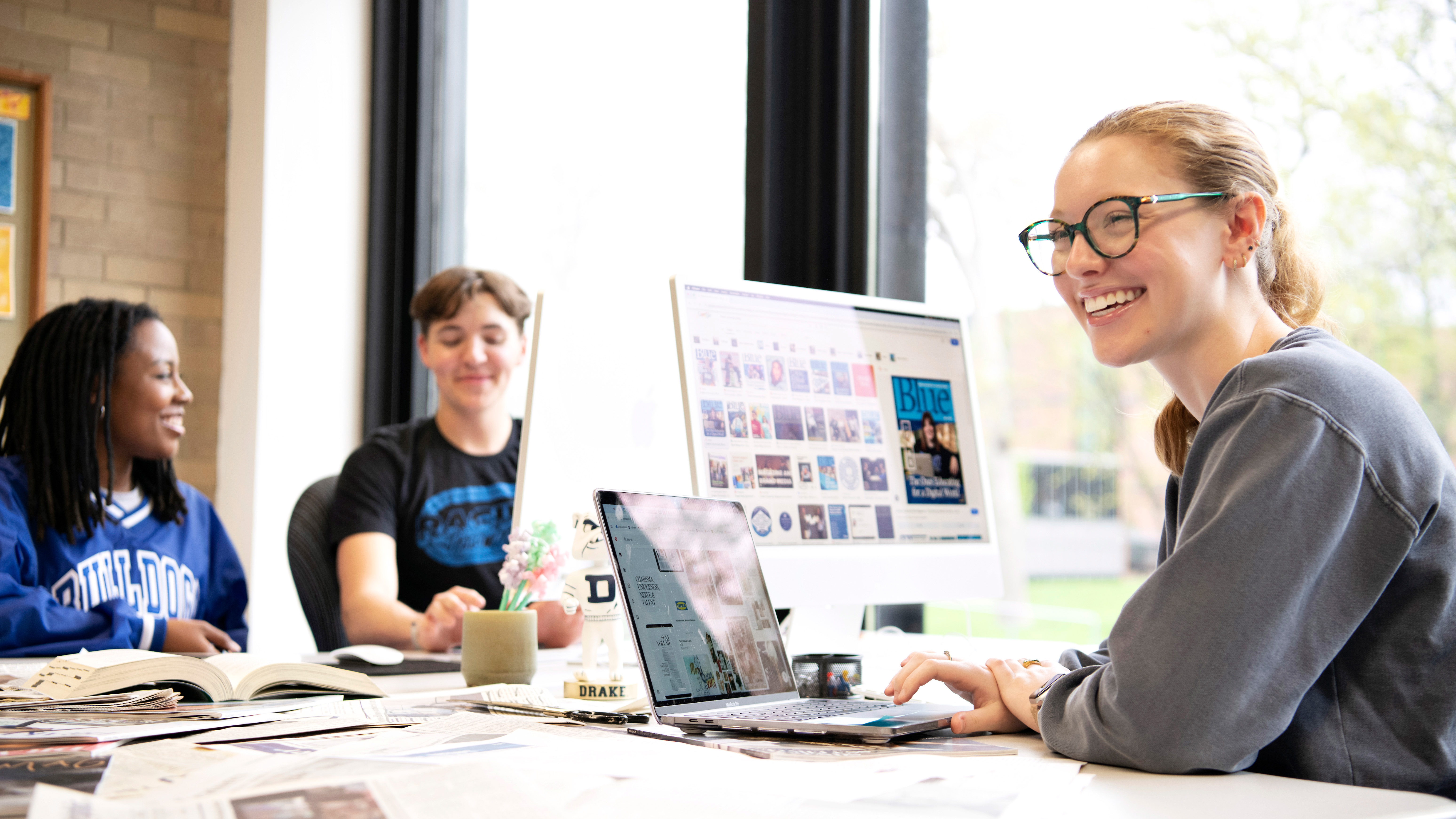 Drake Graphic Design students work on projects in a well-lit campus computer lab
