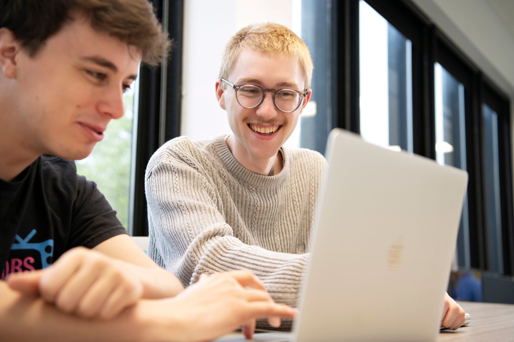 Two Drake Graphic Design students collaborate on a project for an internship