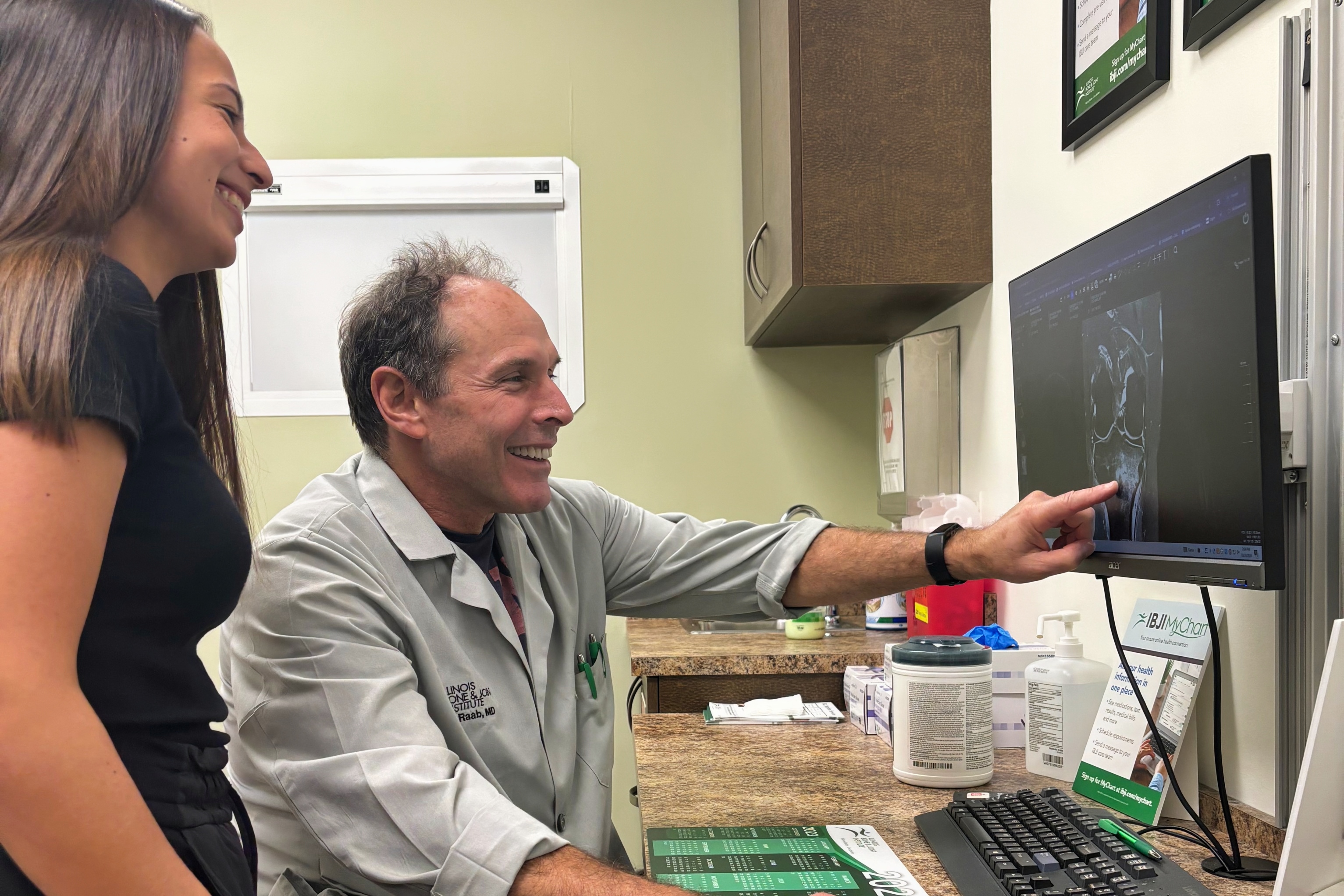 A professor for Drake's Health Sciences major points to a screen to show a student how to examine imaging results
