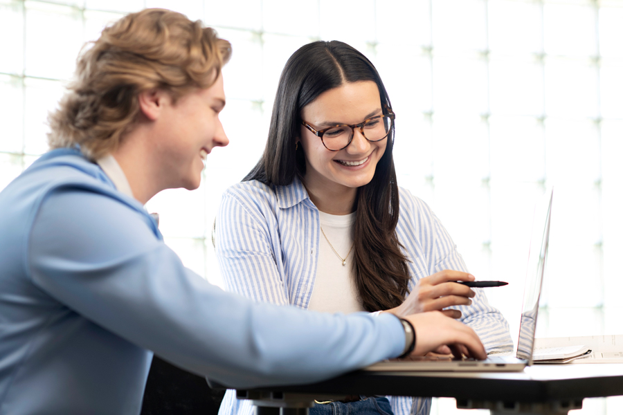 Two students in Drake's Interdisciplinary Study of the Humanities and Sciences program explore different career possibilities in a campus common area
